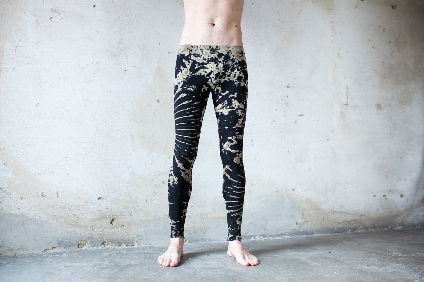 Mann trägt elastische Unisex Batik Blumen Leggings schwarz-beige-grau – Yoga Psytrance Punk Alternative Mode Festival Style