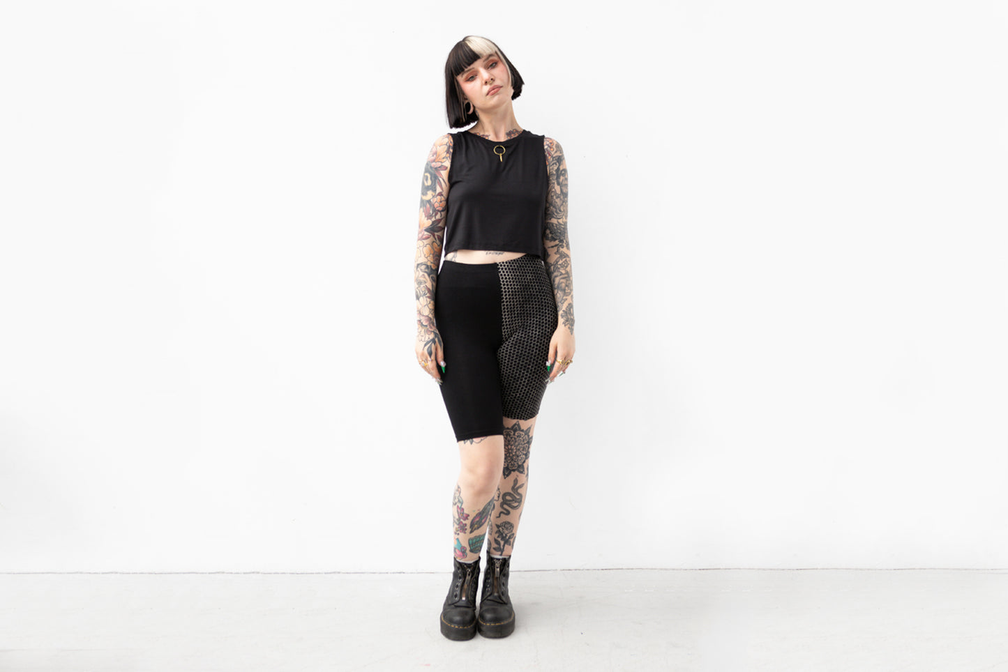 Alternatives Model trägt Mid-Waist Biker Shorts mit asymmetrischem Design für Yoga und Alltag.