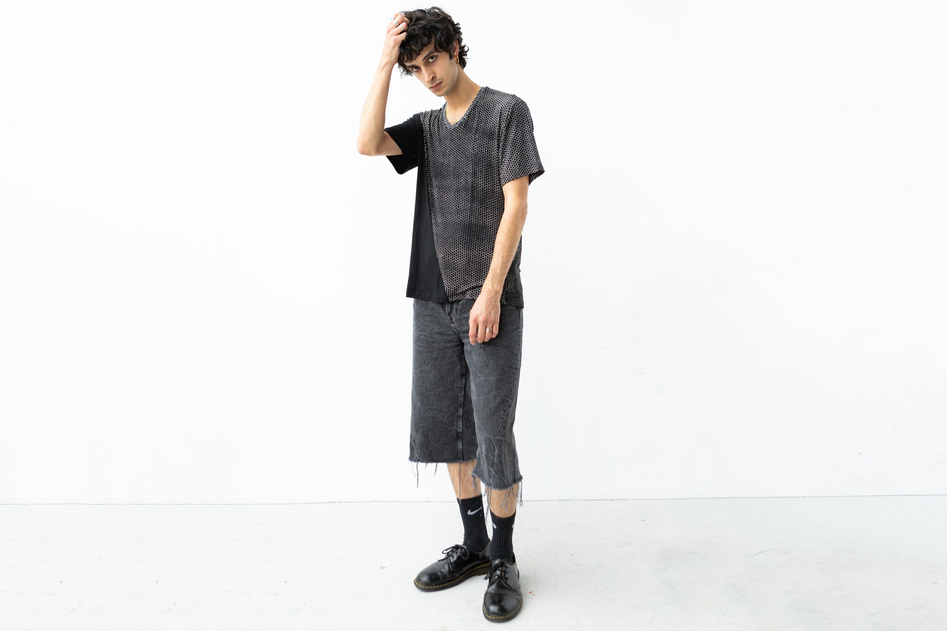 Schwarzes T-Shirt mit abstraktem Hexagon-Design Frontansicht.