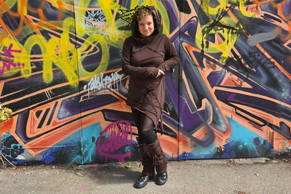 Model mit braunem Kapuzenkleid, Spitzen-Beinstulpen mit Schnürung und schwarzer Mesh-Leggings