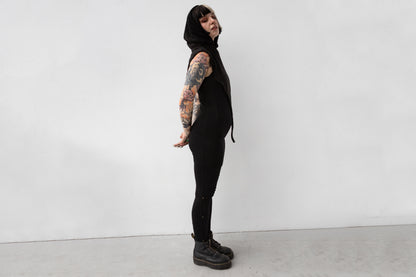 Weiblich gelesenes Model trägt Schalkapuze mit asymmetrischem Schnitt und großem Zipfel